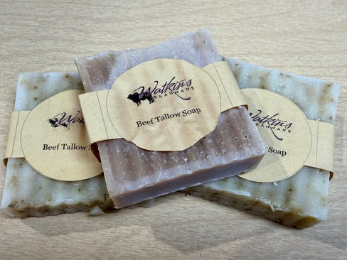 Three bars of beef tallow soap with Walford's & Sons branding on a wooden surface.